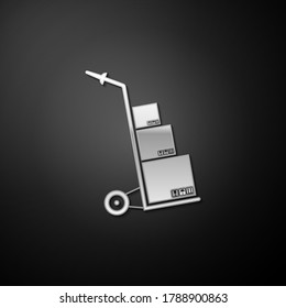 Silver Hand truck and boxes icon isolated on black background. Dolly symbol. Long shadow style. Vector.