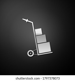 Silver Hand truck and boxes icon isolated on black background. Dolly symbol. Long shadow style. Vector.