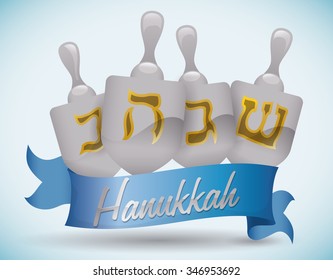 Silver Hanukkah's dreidels with golden symbols and blue ribbon.