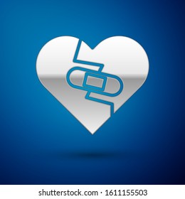 Silver Healed broken heart or divorce icon isolated on blue background. Shattered and patched heart. Love symbol. Valentines day.  Vector Illustration