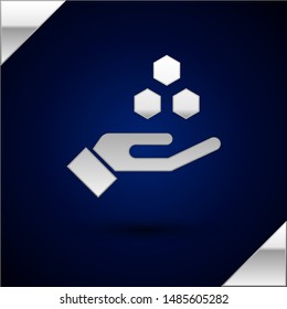 Silver Honeycomb and hand icon isolated on dark blue background. Honey cells symbol. Sweet natural food.  Vector Illustration