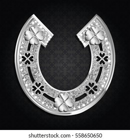 Silver horseshoe with four-leaf clover on a dark background. Vector illustration