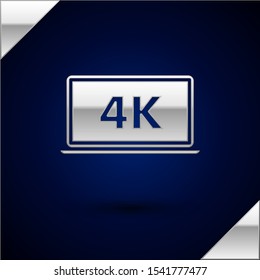 Silver Laptop screen with 4k video technology icon isolated on dark blue background.  Vector Illustration