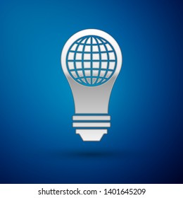 Silver Light bulb with inside world globe icon isolated on blue background. Planet Earth on the lamp. Global ecology concept. Vector Illustration