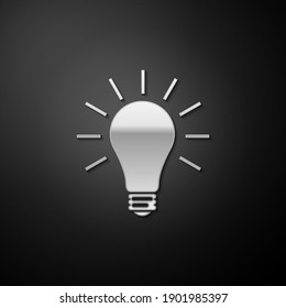 Silver Light bulb with rays shine icon isolated on black background. Energy and idea symbol. Lamp electric. Long shadow style. Vector.