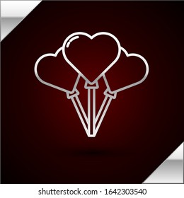 Silver line Balloons in form of heart with ribbon icon isolated on dark red background.  Vector Illustration