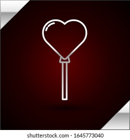 Silver line Balloons in form of heart with ribbon icon isolated on dark red background.  Vector Illustration