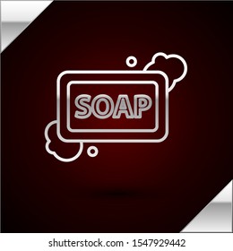Silver line Bar of soap with foam icon isolated on dark red background. Soap bar with bubbles.  Vector Illustration
