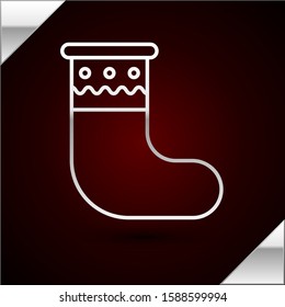 Silver line Christmas stocking icon isolated on dark red background. Merry Christmas and Happy New Year.  Vector Illustration