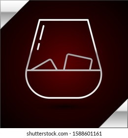 Silver line Glass of whiskey and ice cubes icon isolated on dark red background.  Vector Illustration