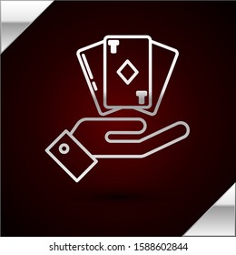 Silver line Hand holding deck of playing cards icon isolated on dark red background. Casino gambling.  Vector Illustration