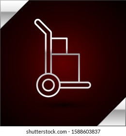 Silver line Hand truck and boxes icon isolated on dark red background. Dolly symbol.  Vector Illustration