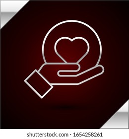 Silver line Heart on hand icon isolated on dark red background. Hand giving love symbol.  Vector Illustration