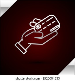 Silver line Human hand holding with credit card icon isolated on dark red background. Online payment. Pay by card. Financial operations.  Vector Illustration