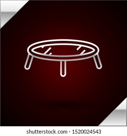 Silver line Jumping trampoline icon isolated on dark red background.  Vector Illustration