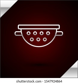Silver line Kitchen colander icon isolated on dark red background. Cooking utensil. Cutlery sign.  Vector Illustration
