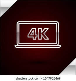 Silver line Laptop screen with 4k video technology icon isolated on dark red background.  Vector Illustration