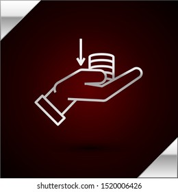 Silver line Money on hand icon isolated on dark red background. Palm holds cash with down. Cash salary decrease.  Vector Illustration