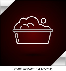 Silver line Plastic basin with soap suds icon isolated on dark red background. Bowl with water. Washing clothes, cleaning equipment.  Vector Illustration