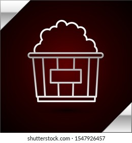 Silver line Popcorn in cardboard box icon isolated on dark red background. Popcorn bucket box.  Vector Illustration