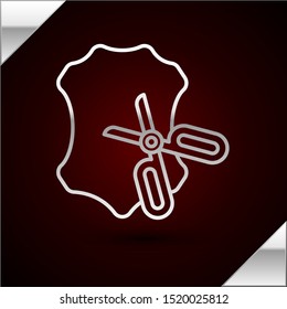 Silver line Scissors and leather icon isolated on dark red background. Tailor symbol. Cutting tool sign.  Vector Illustration