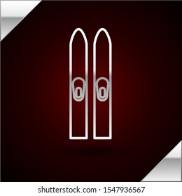 Silver line Ski and sticks icon isolated on dark red background. Extreme sport. Skiing equipment. Winter sports icon.  Vector Illustration