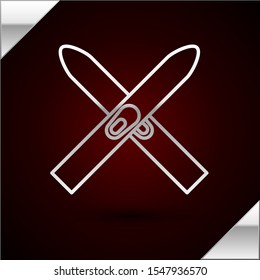 Silver line Ski and sticks icon isolated on dark red background. Extreme sport. Skiing equipment. Winter sports icon.  Vector Illustration