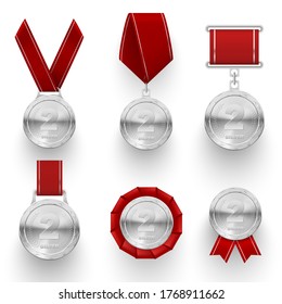 Silver medals with red ribbons, rosette, laurel wreaths realistic set. Metal awards in competition, sport prizes for runner up. Second place round medallions. Vector medals isolated on white.