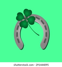 silver metal horseshoe and green cloverleaf eps10