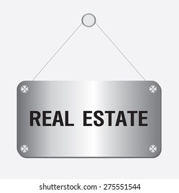 silver metallic real estate sign hanging on the wall