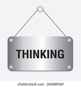 silver metallic thinking sign hanging on the wall 