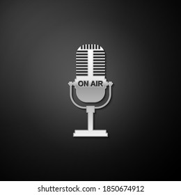 Silver Microphone icon isolated on black background. On air radio mic microphone. Speaker sign. Long shadow style. Vector.