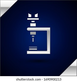 Silver Microscope icon isolated on dark blue background. Chemistry, pharmaceutical instrument, microbiology magnifying tool.  Vector Illustration