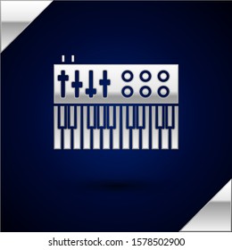 Silver Music synthesizer icon isolated on dark blue background. Electronic piano.  Vector Illustration