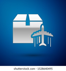Silver Plane and cardboard box icon isolated on blue background. Delivery, transportation. Cargo delivery by air. Airplane with parcels, boxes.  Vector Illustration