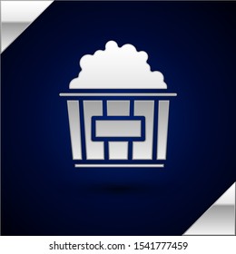 Silver Popcorn in cardboard box icon isolated on dark blue background. Popcorn bucket box.  Vector Illustration
