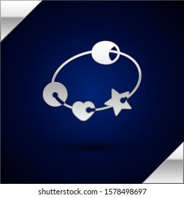 Silver Rattle baby toy icon isolated on dark blue background. Vector Illustration