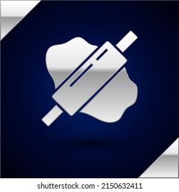 Silver Rolling pin on dough icon isolated on dark blue background.  Vector