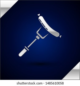 Silver Sausage on the fork icon isolated on dark blue background. Grilled sausage and aroma sign.  Vector Illustration