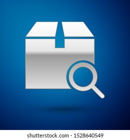 Silver Search package icon isolated on blue background. Parcel tracking symbol. Magnifying glass and cardboard box. Logistic and delivery.  Vector Illustration
