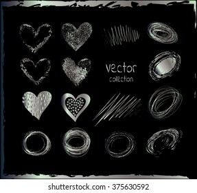  Silver set of the hand drawing hearts, isolated on black.  Silver shapes on a black background.