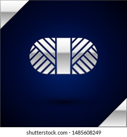 Silver Sewing thread on spool icon isolated on dark blue background. Yarn spool. Thread bobbin.  Vector Illustration