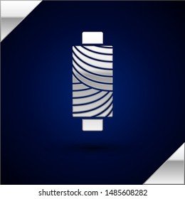 Silver Sewing thread on spool icon isolated on dark blue background. Yarn spool. Thread bobbin.  Vector Illustration