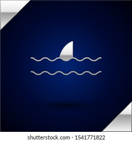 Silver Shark fin in ocean wave icon isolated on dark blue background.  Vector Illustration