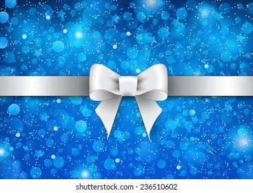 Silver shiny bow on a blue background. Christmas concept.