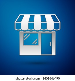 Silver Shopping building or market store icon isolated on blue background. Shop construction. Vector Illustration
