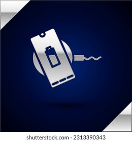 Silver Smartphone charging on wireless charger icon isolated on dark blue background. Charging battery on charging pad.  Vector Illustration