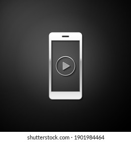 Silver Smartphone with play button on the screen icon isolated on black background. Long shadow style. Vector.