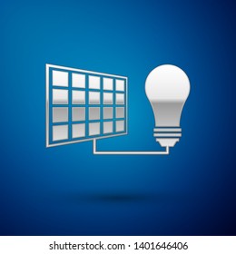 Silver Solar energy panel and light bulb icon isolated on blue background. Vector Illustration
