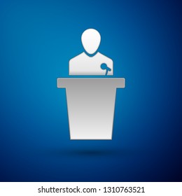 Silver Speaker icon isolated on blue background. Orator speaking from tribune. Public speech. Person on podium. Vector Illustration
